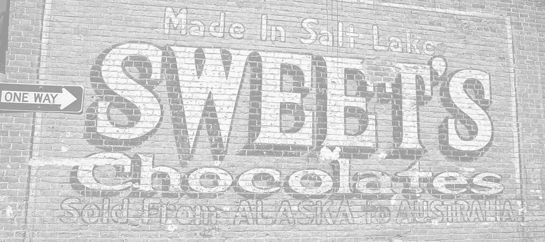 Historical Photo - Sweet's Chocolate On Brick Wall - Contact Us